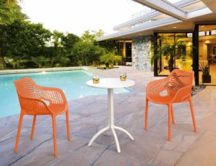 2 Orange Air XL Chairs and White Octopus Table Set in the Garden by the Pool