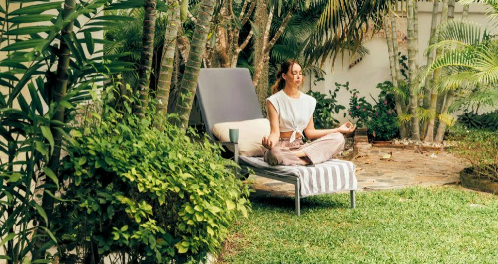 meditating in garden on sun lounger